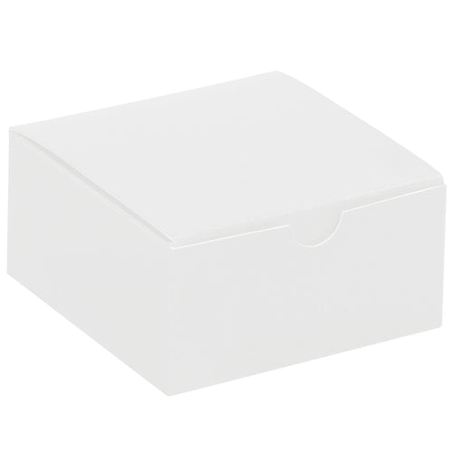 Industrial-strength white fibreboard gift boxes sized 4x4x2 inches with convenient one-piece construction that sets up in seconds. Case of 100 units ships and stores flat, reducing warehouse costs and shipping expenses. Gray interior contrasts with white exterior for professional retail and novelty packaging.