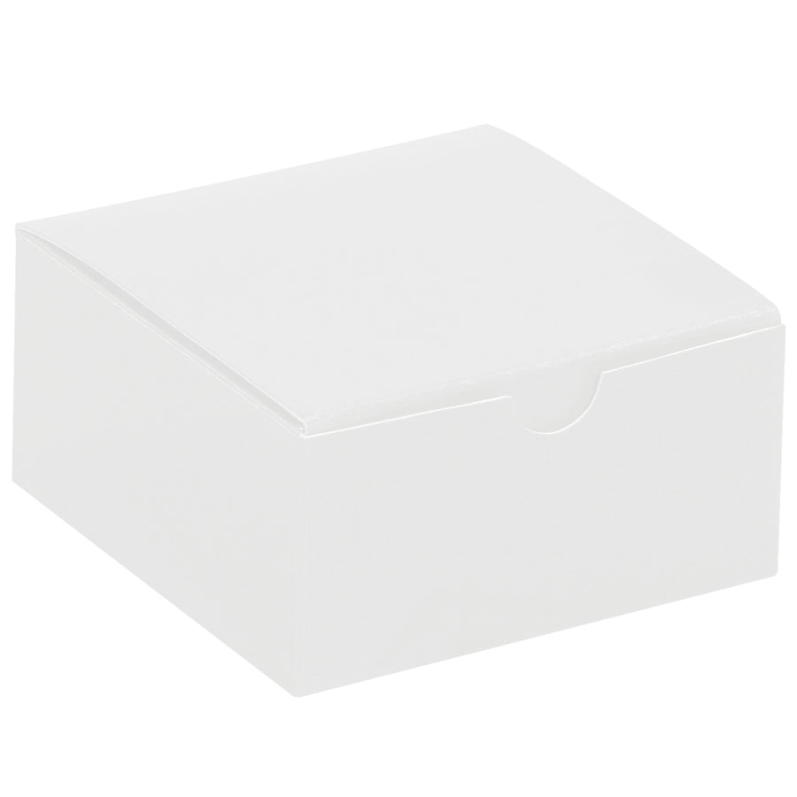 Industrial-strength white fibreboard gift boxes sized 4x4x2 inches with convenient one-piece construction that sets up in seconds. Case of 100 units ships and stores flat, reducing warehouse costs and shipping expenses. Gray interior contrasts with white exterior for professional retail and novelty packaging.