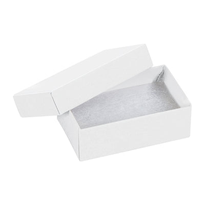 Professional-grade white jewelry boxes measuring 2.5" x 1.5" x 0.875" built from rigid fibreboard with jeweler's cotton filler included. Two-piece construction arrives fully assembled, ready to pack. Purchase by the case of 100 units for maximum cost efficiency.
